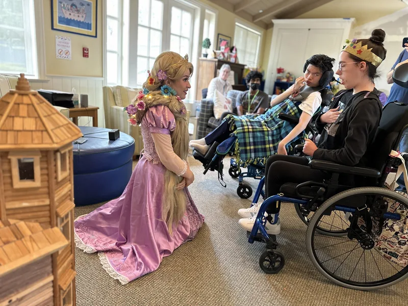 Jordyn Foley, dressed as Rapunzel, with young patients at George Mark Children&rsquo;s House